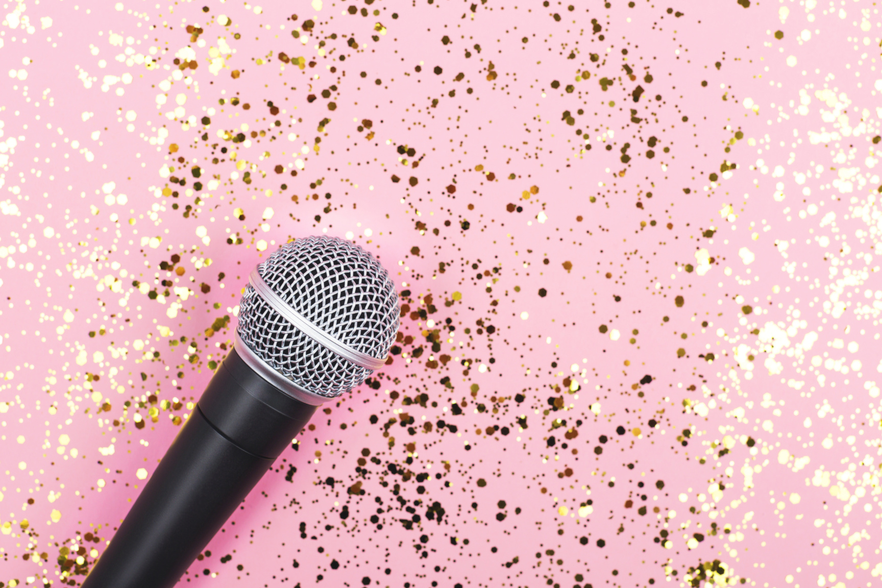Microphone on Pink Background Decorated with Confetti